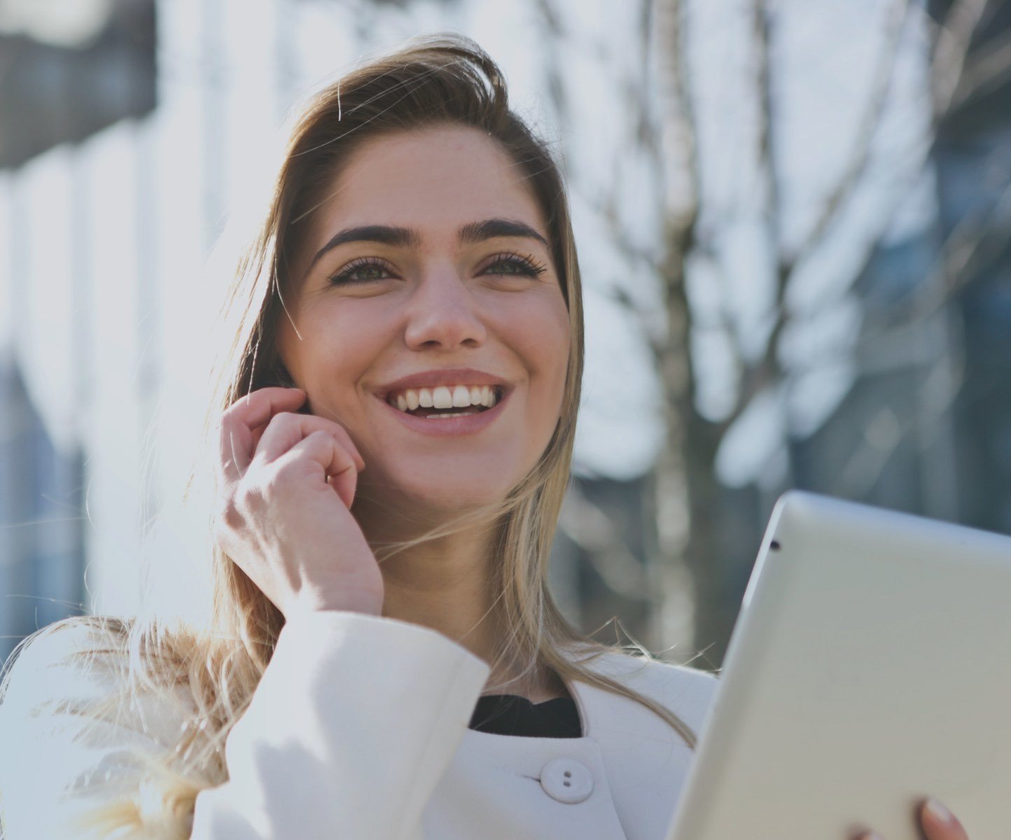 Female graduate using mobile phone